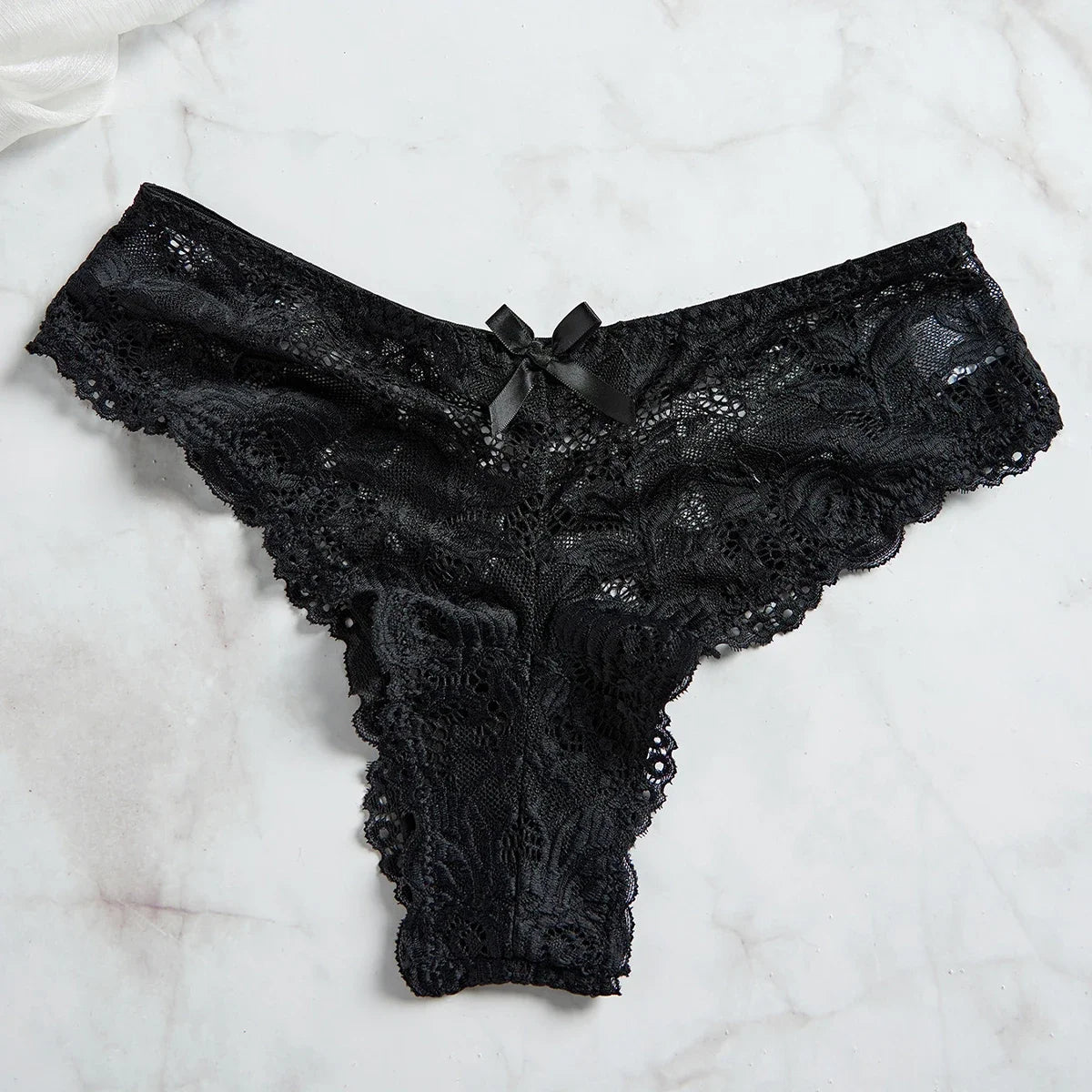 Black lace thong panty with scalloped edges on marble background part of EtherealBe lace nightgown set for women