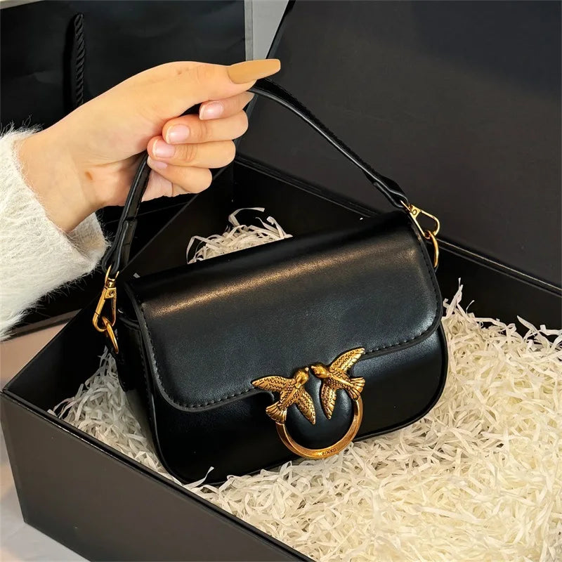 Black leather versatile small square tote bag styled as a compact shoulder purse with gold bird ring hardware