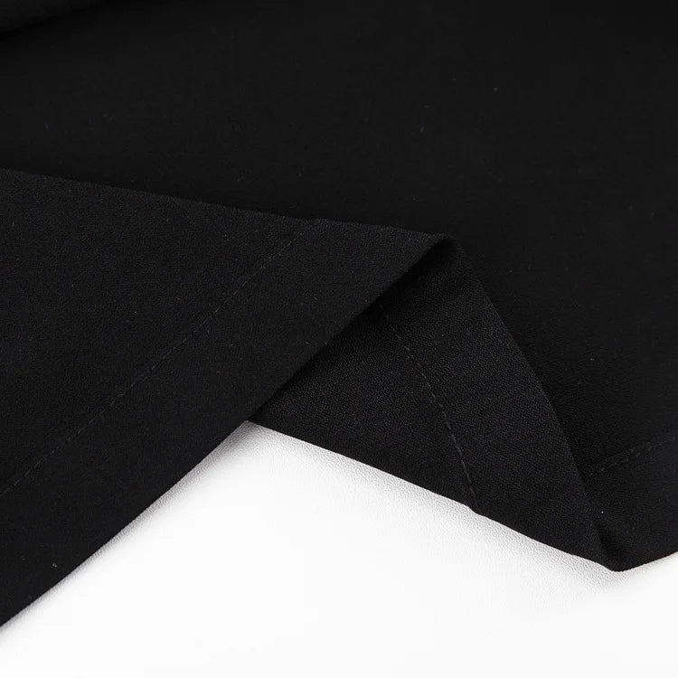 Close-up of the smooth fabric of a black high waist maxi skirt by EtherealBe