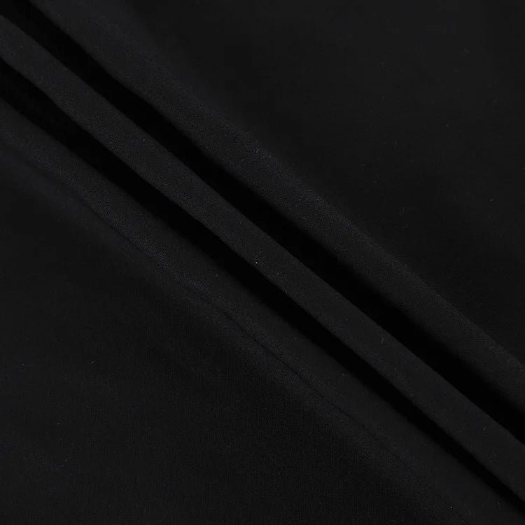 Close-up view of black high waist maxi skirt fabric with smooth texture and elegant drape