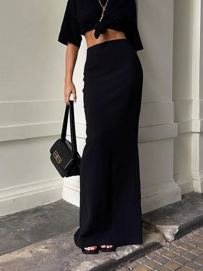 Elegant black high waist maxi skirt paired with a cropped top for a chic look