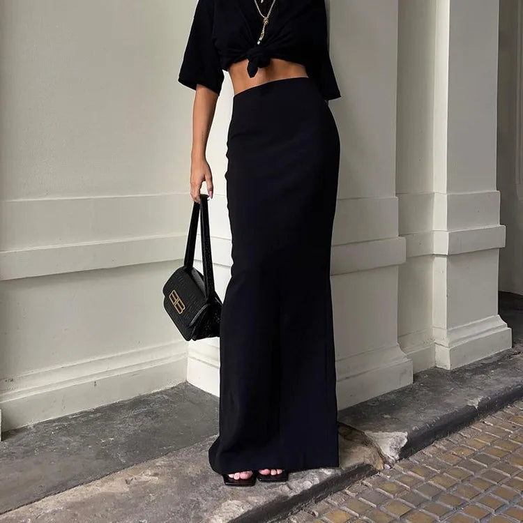 Chic black high waist maxi skirt paired with a crop top for a stylish look
