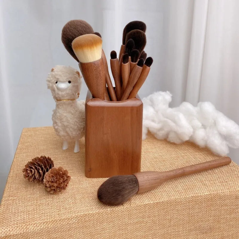 EtherealBe black walnut makeup brush set displayed in a wooden holder with decorative items
