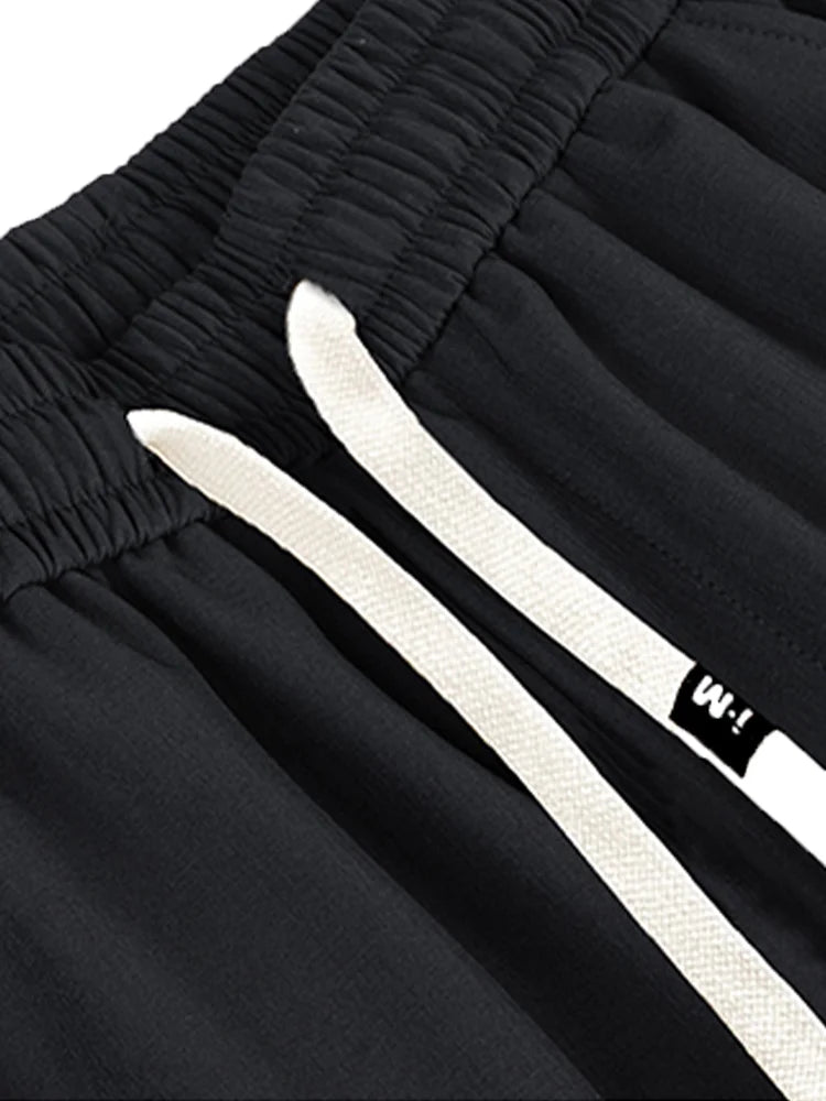Close-up of black wide leg cargo pants women showcasing elastic waistband and drawstring detail