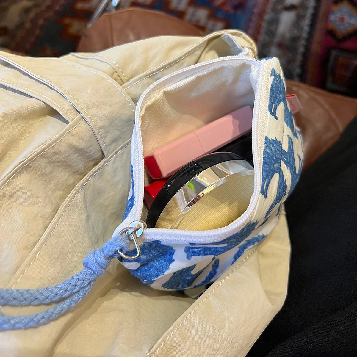 EtherealBe blue cat makeup bag with cosmetics neatly stored inside for easy access