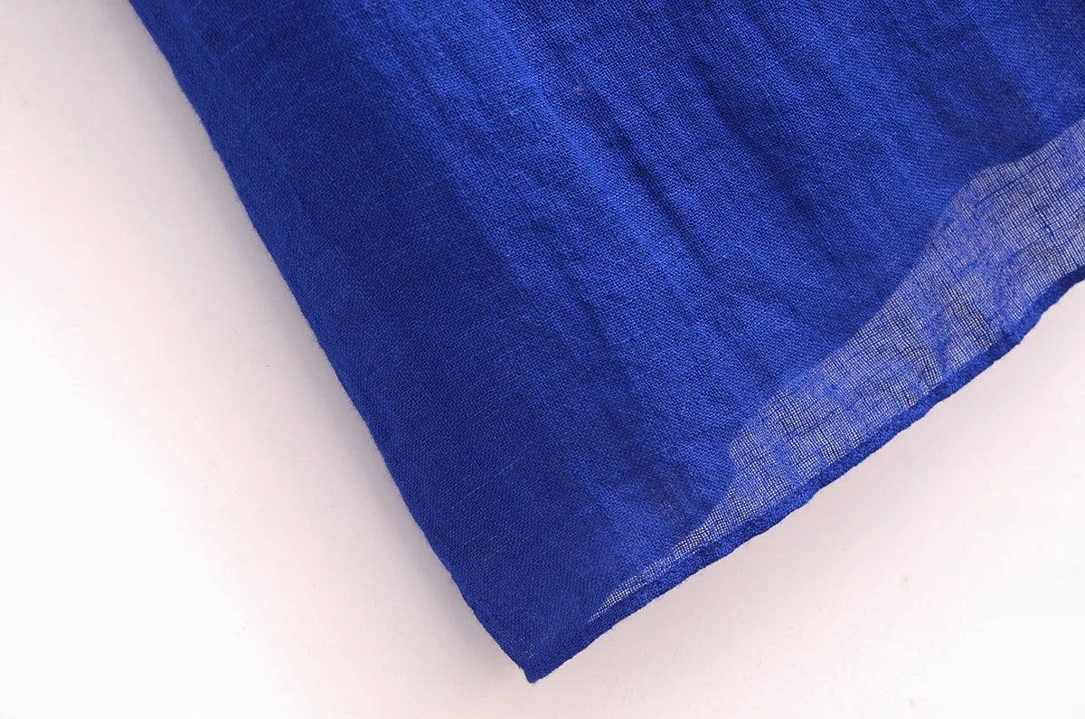 Close-up of soft fabric of a blue halter backless summer dress by EtherealBe