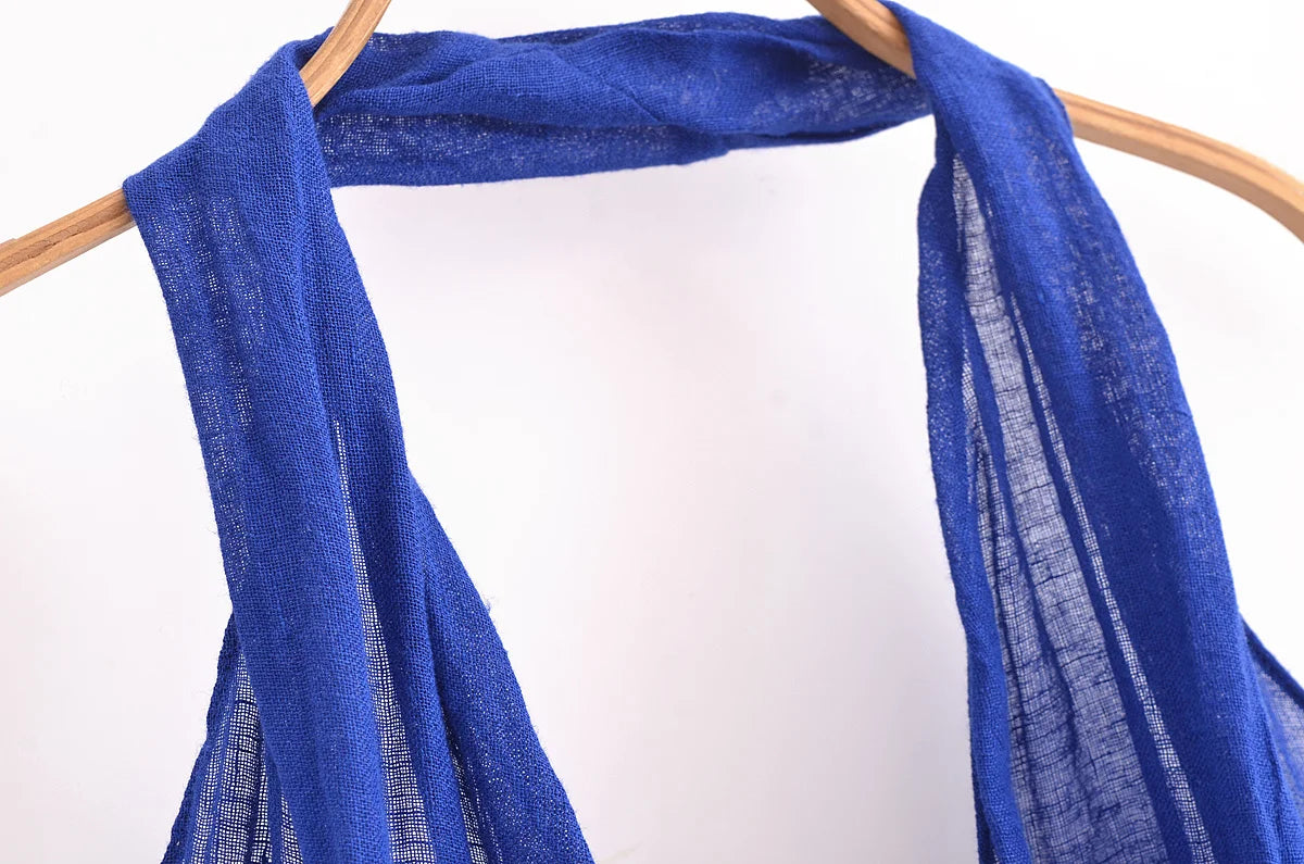 Close-up of a blue halter backless summer dress showcasing the fabric and draping details