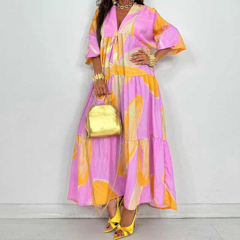 EtherealBe elegant printed v-neck maxi dress in pink and orange with tiered skirt gold bag and yellow heels