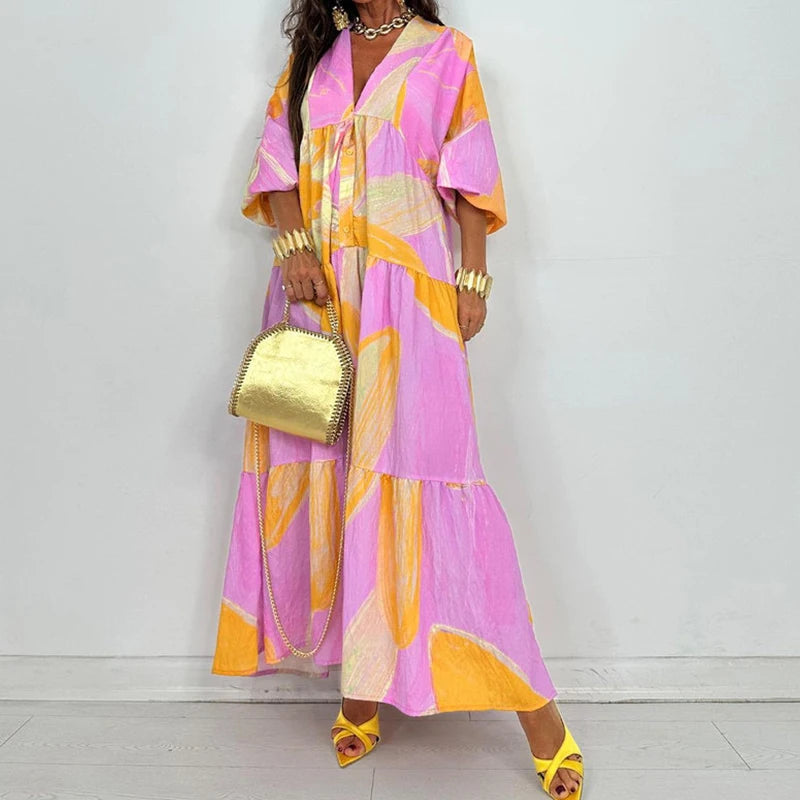 EtherealBe elegant printed v-neck maxi dress in pink and yellow abstract print with tiered skirt and short sleeves