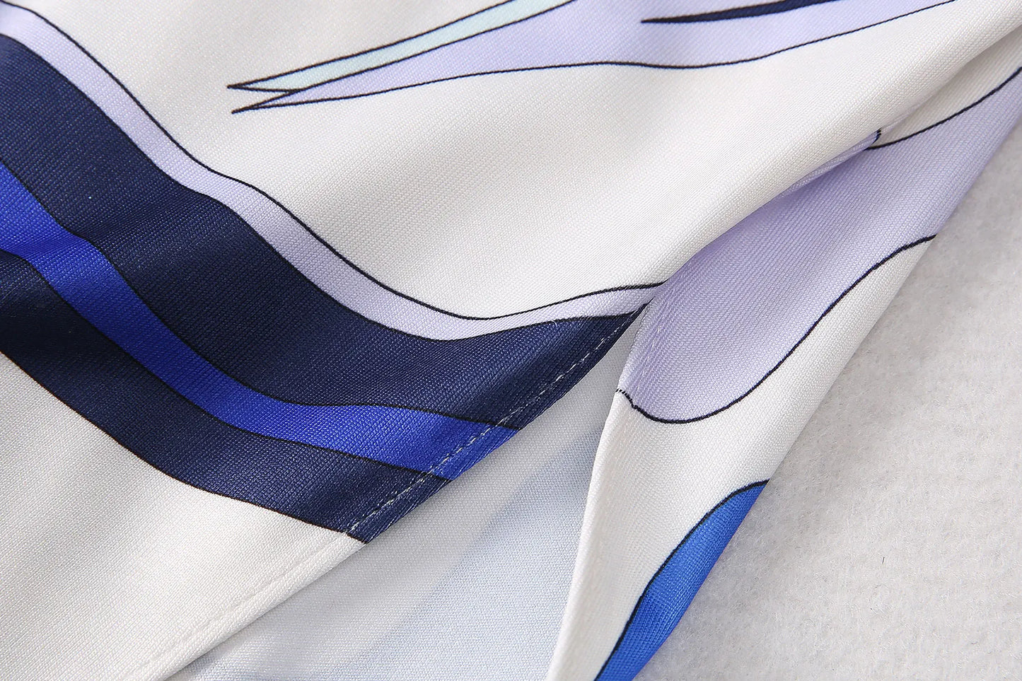 Close-up of EtherealBe breathable round neck fashion vestido fabric featuring colorful wave patterns
