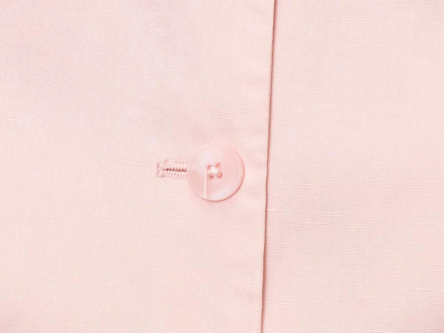 Close-up of a button on a pink blouse from EtherealBe, part of a casual chic office lady pantsuit