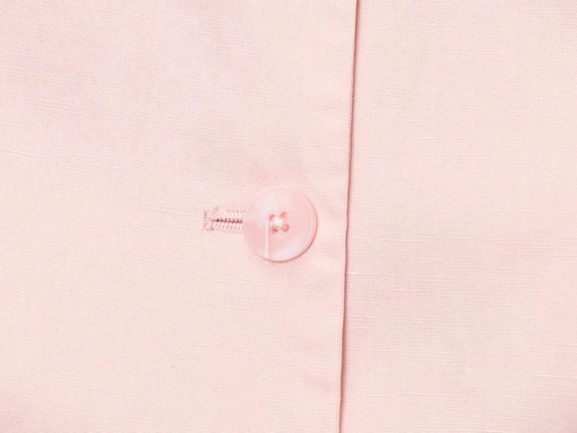 Close-up of a button on a pink blouse from EtherealBe, part of a casual chic office lady pantsuit