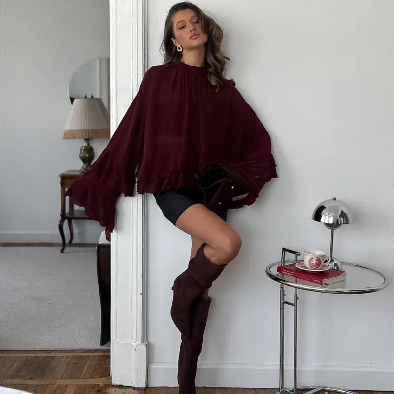 Chic long sleeve o-neck sheer top in burgundy, paired with stylish shorts and knee-high boots