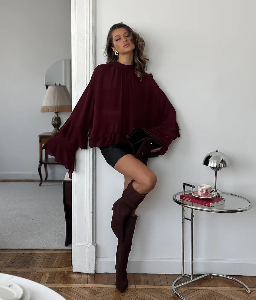 EtherealBe chic long sleeve o-neck sheer top in burgundy paired with a mini skirt and knee-high boots