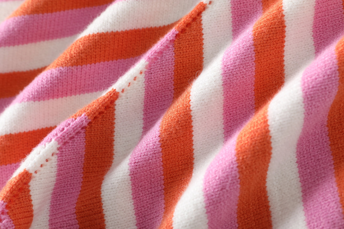 Chic sleeveless lace-up halter dress in vibrant striped fabric showcasing pink and orange patterns
