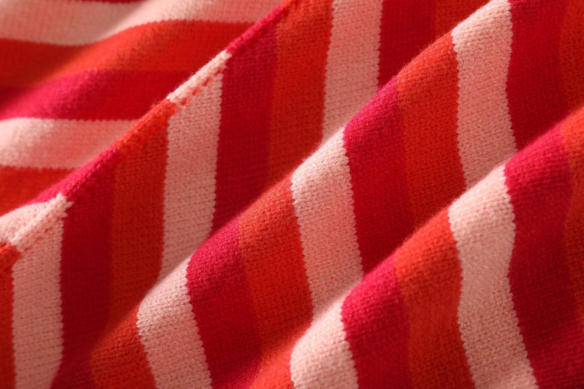 Chic sleeveless lace-up halter dress in vibrant red and pink striped fabric close-up