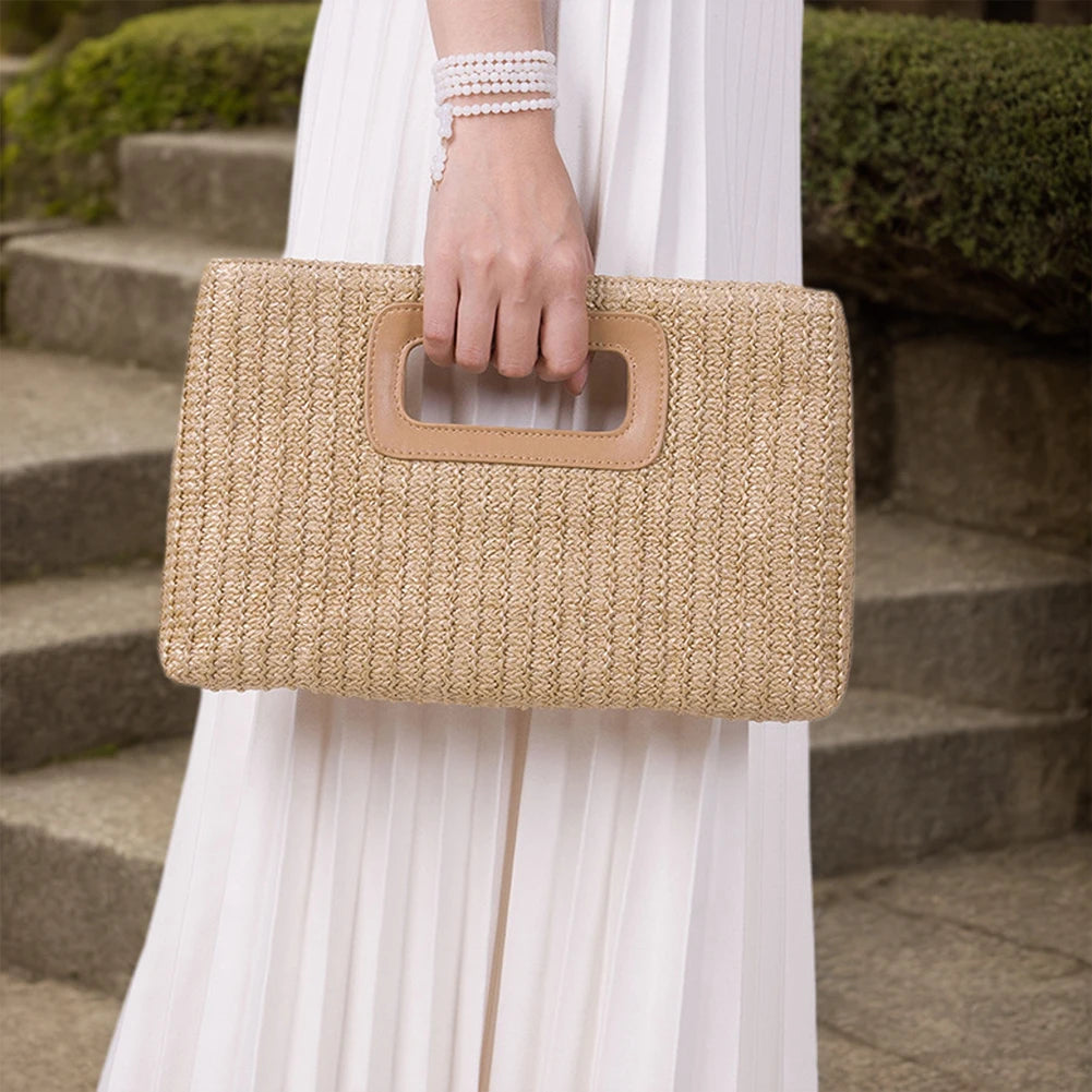 Chic straw woven shoulder bag held by a model in elegant attire, ideal for summer outings