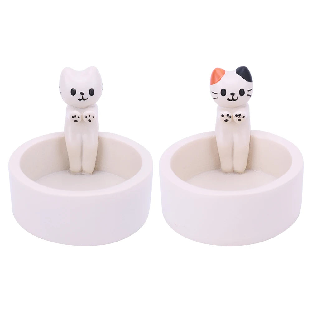 Set of two cute cat tealight holders featuring playful cat figurines in a white base