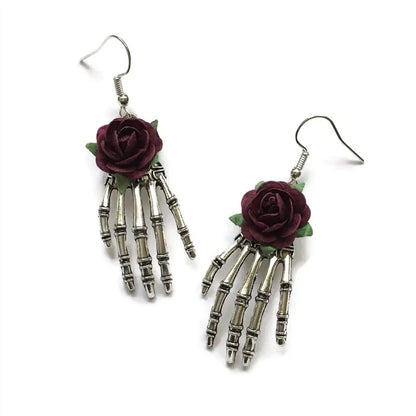 Dark punk rose jewelry for girls featuring vintage skeleton hand earrings with purple roses