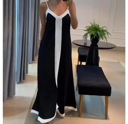 Elegant black and white sleeveless maxi dress with a flowing design and a stylish silhouette