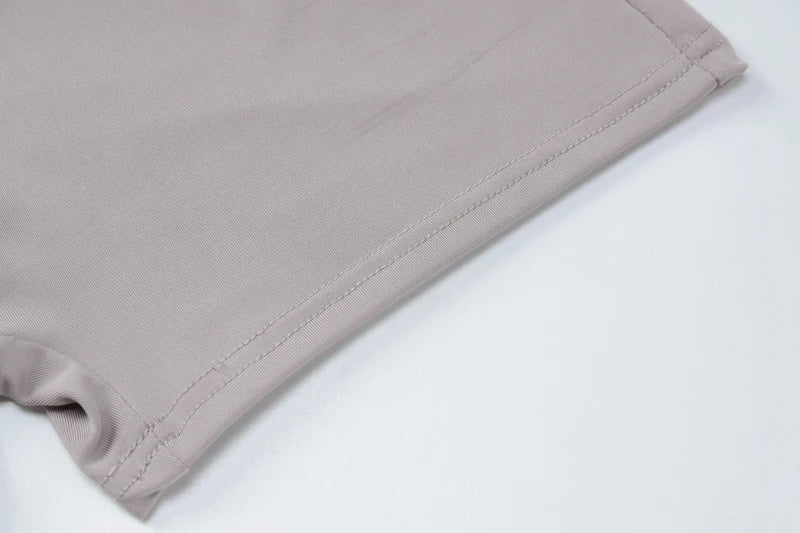 EtherealBe beige stretch fabric close up hem and stitching detail of bodycon romper for women
