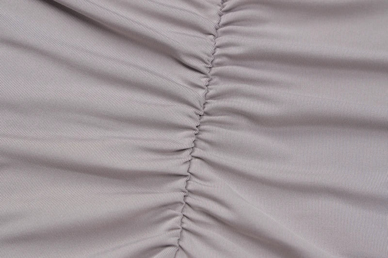 Light mauve ruched stretch fabric closeup showing center seam on bodycon romper for women
