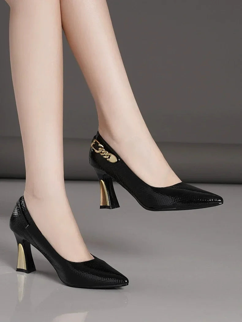 EtherealBe elegant designer party pumps in black with stylish gold accents and a chic pointed toe.