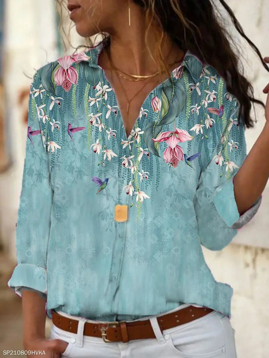 EtherealBe elegant floral print blouse for women featuring a blue background and vibrant flower designs