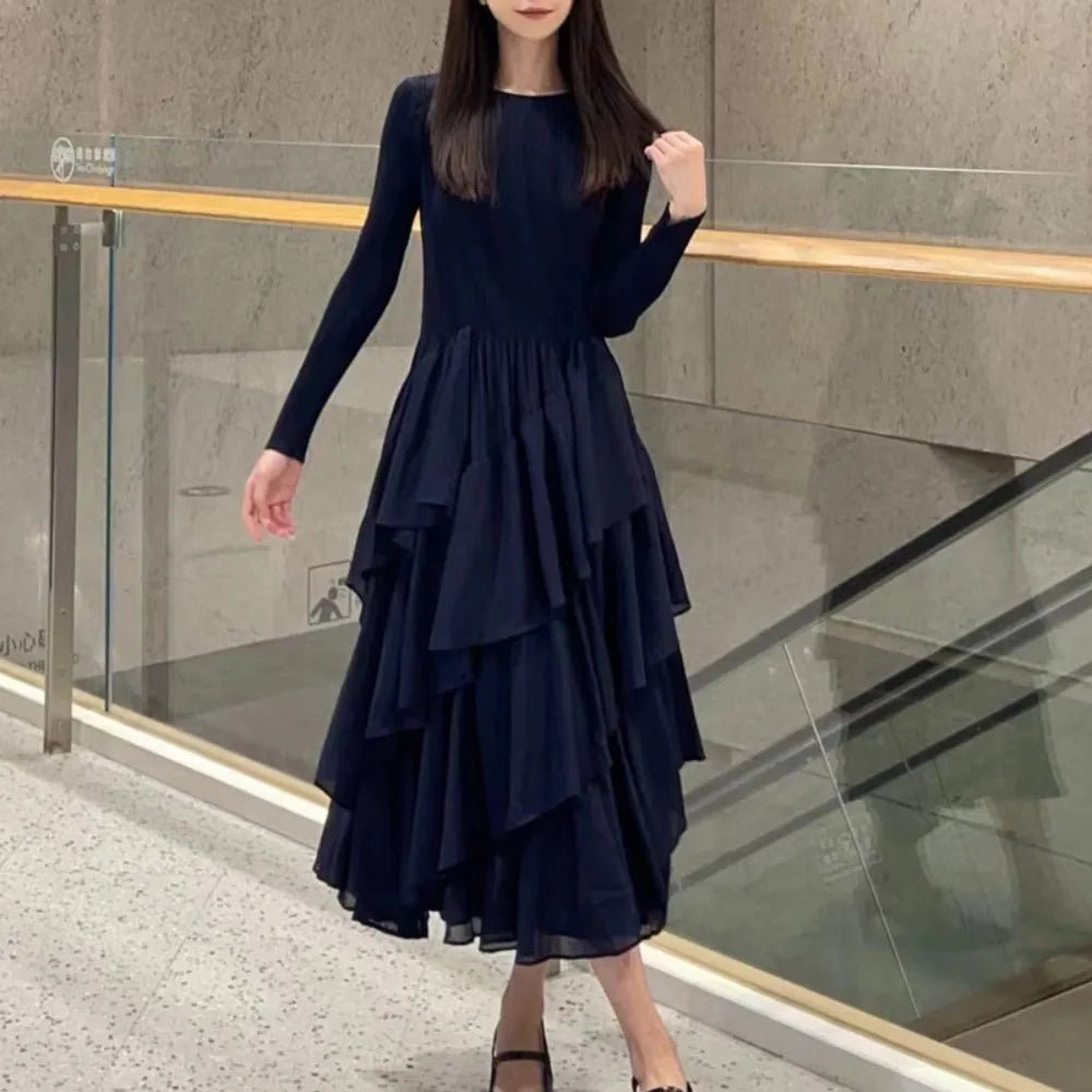 Elegant layered ruffle cake dress in navy with long sleeves and a flowy silhouette