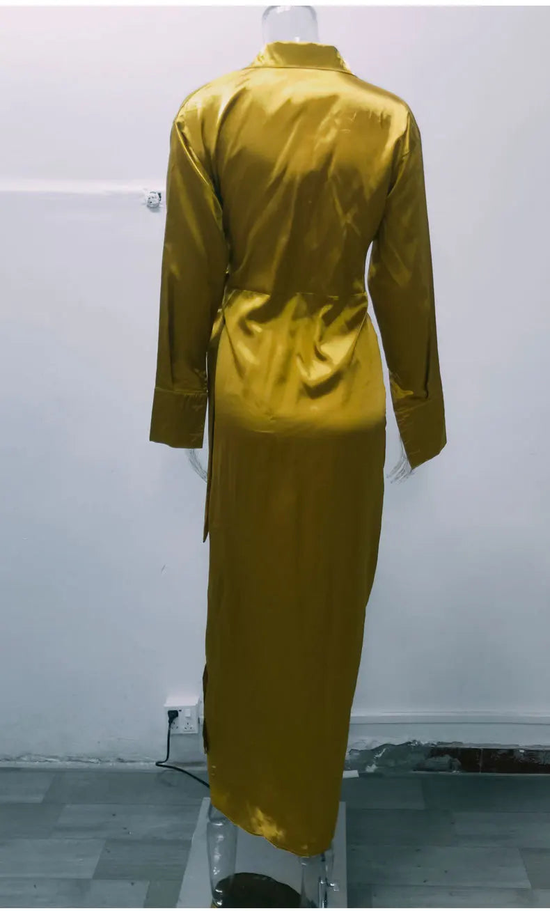Back view of an elegant long sleeve split dress in yellow, showcasing a sleek design and satin finish