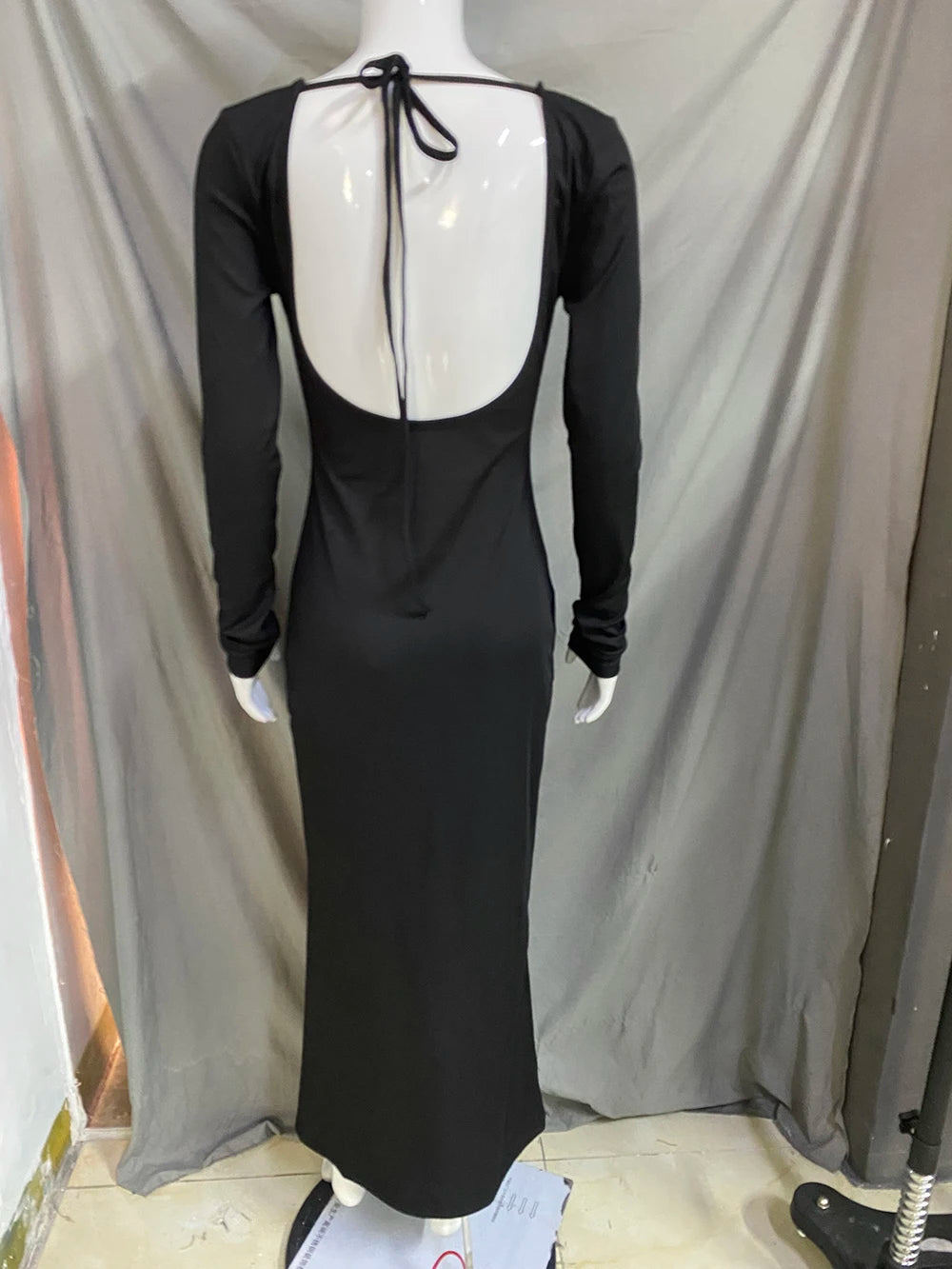 Elegant off shoulder evening dress in black featuring a deep back with tie closure for a sophisticated look