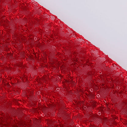 Close-up of elegant red fabric with intricate lace patterns for elegant prom and gala dresses