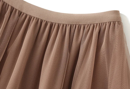 Close-up of the waistband and fabric of an elegant ruffle edge skirt for women in soft brown color