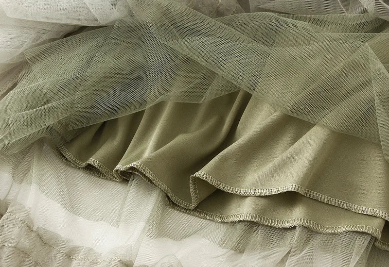 Close-up of elegant ruffle edge skirt for women in soft olive green fabric with layered design