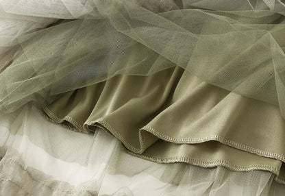 Close-up of elegant ruffle edge skirt for women in soft olive green fabric with layered design