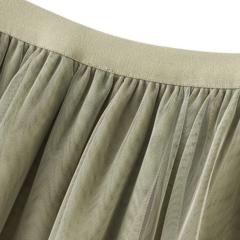 Close-up of a soft fabric showcasing the elegant ruffle edge skirt for women in a neutral tone