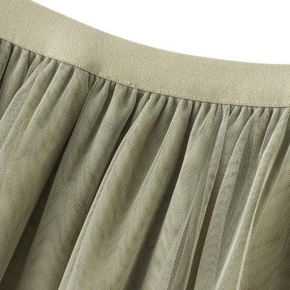 Close-up of a soft fabric showcasing the elegant ruffle edge skirt for women in a neutral tone