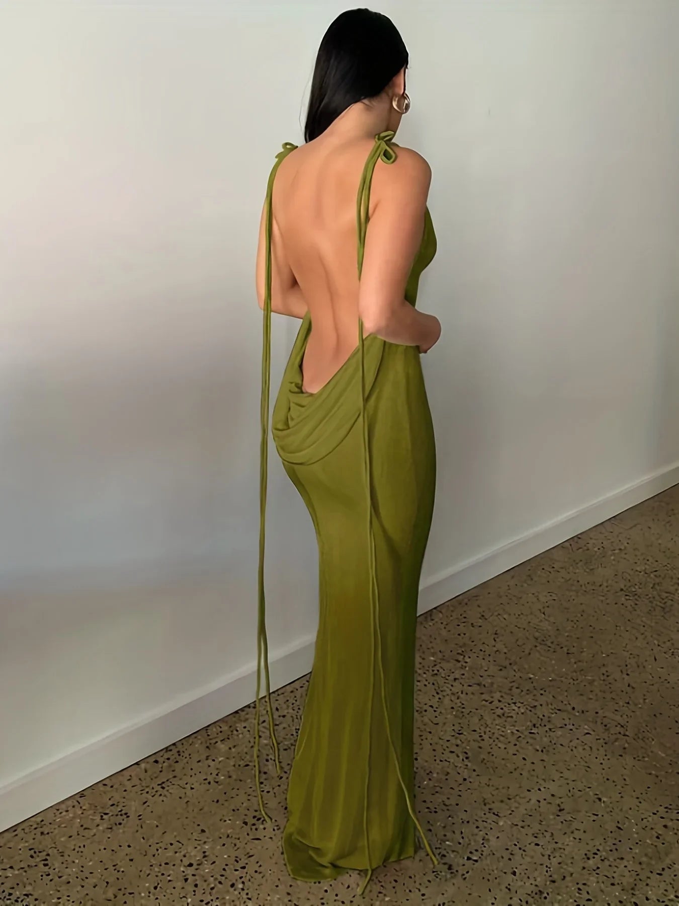 Elegant womens strapless evening gown in olive green with a dramatic open back and adjustable tie straps