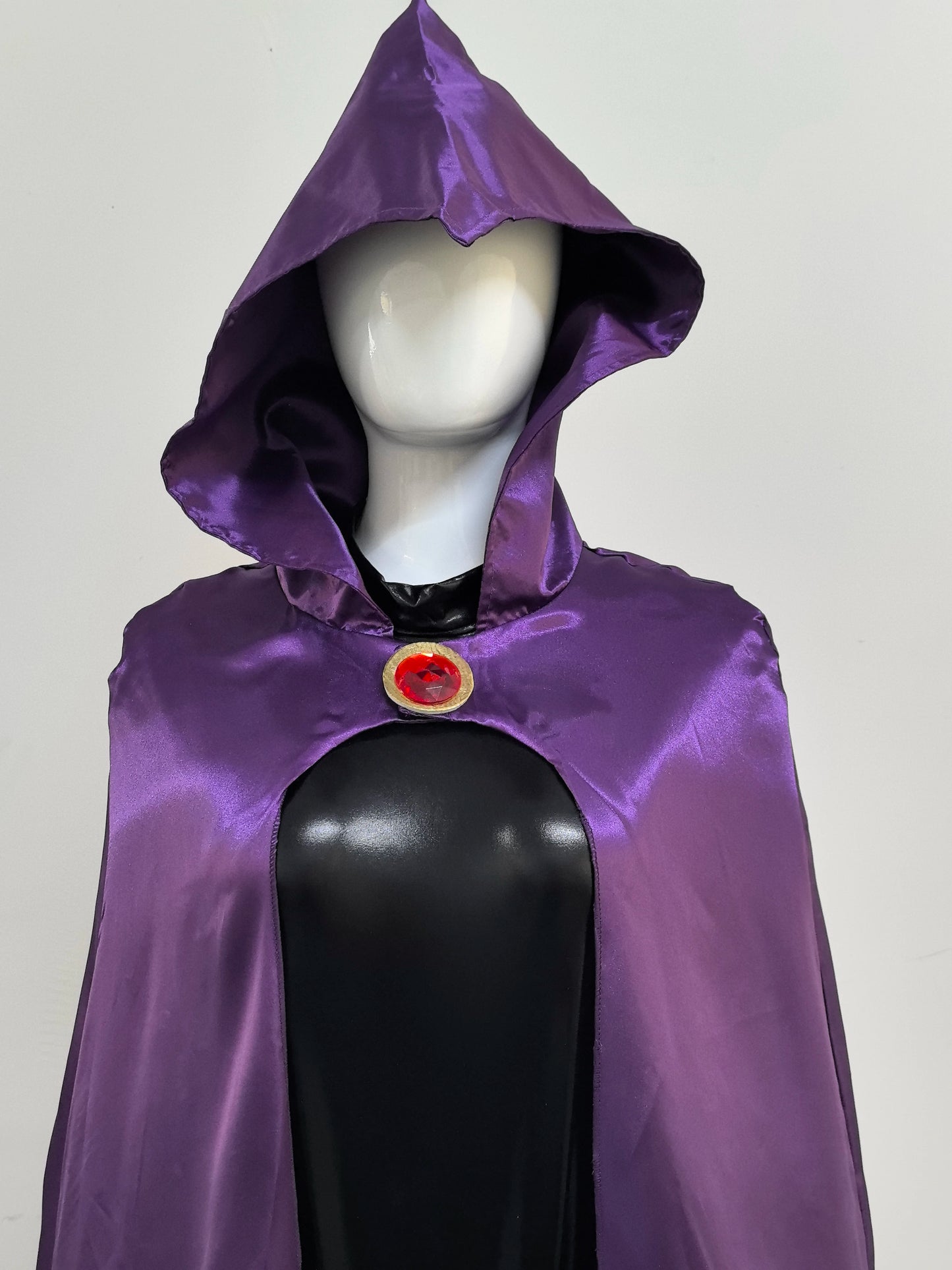 Raven Teen Titans cosplay costume featuring a purple hooded cape with a circular red gem detail