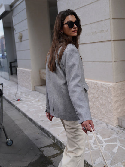 Stylish Fashion Blazer for women in gray, paired with cream trousers for a chic look