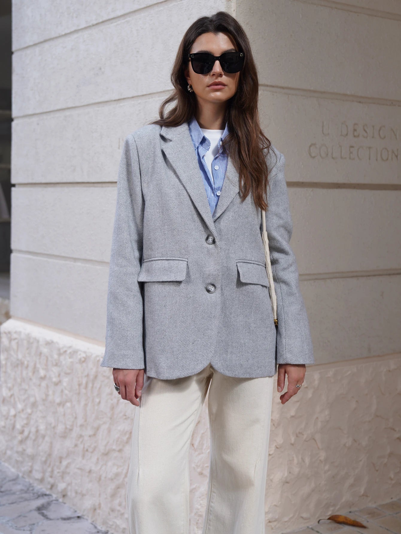 Stylish gray EtherealBe Fashion Blazer for women, paired with a blue shirt and cream pants in an outdoor setting