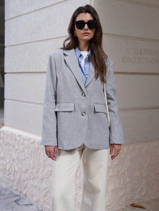 Stylish gray EtherealBe Fashion Blazer for women, paired with a blue shirt and cream pants in an outdoor setting