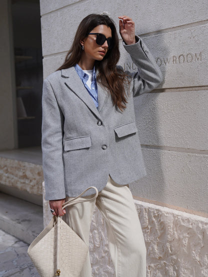 Stylish gray Fashion Blazer for women paired with casual wear and sunglasses in an outdoor setting