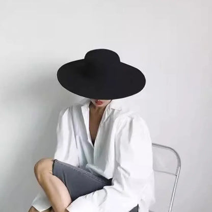 Stylish black fashion blend top hat for ladies paired with a white blouse for a chic look