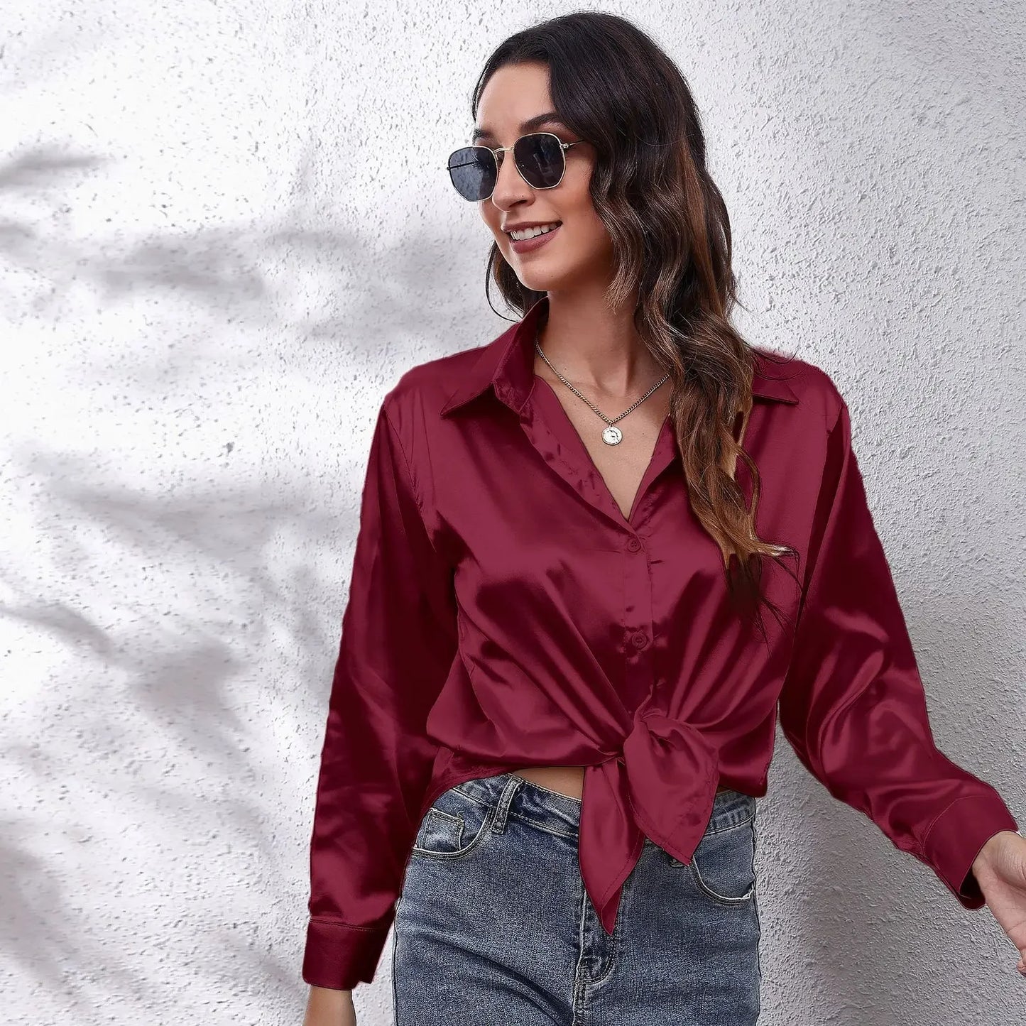 Elegant burgundy fashion satin blouse ladies with a tied front and stylish sunglasses