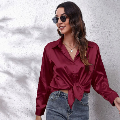 Elegant burgundy fashion satin blouse ladies with a tied front and stylish sunglasses