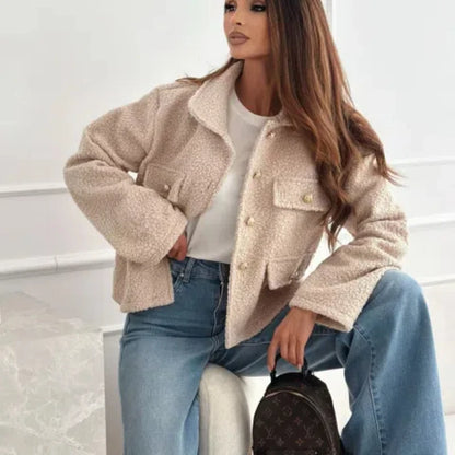 Fashionable woolen short coat for women in beige paired with blue jeans and a stylish handbag