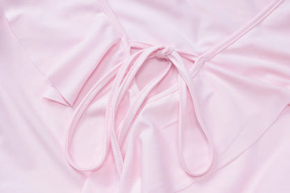 Close-up of the tie detail on a pink flared sleeved v neck ruffle dress from EtherealBe