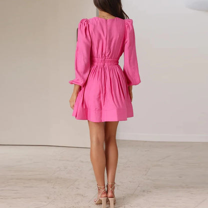 Model wearing EtherealBe elegant v neck long sleeve mini dress in pink with smocked waist and puff sleeves
