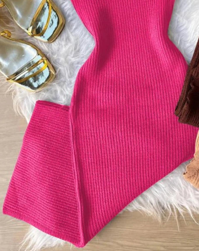 Close-up of a pink ribbed floral beaded bodycon dress laid out with gold heels